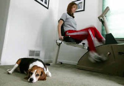 
Michelle Simon, of Royal Oak, Michigan, had disc replacement surgery in November. She exercises on her bike four times a day for seven minutes. Her dog, Benson is in the foreground.
 (KRT / The Spokesman-Review)
