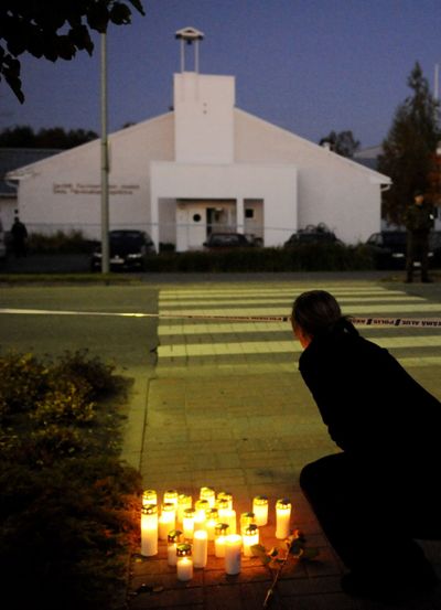 People place candles across from the school where a shooting occurred Tuesday in Kauhajoki, Finland. (Associated Press / The Spokesman-Review)