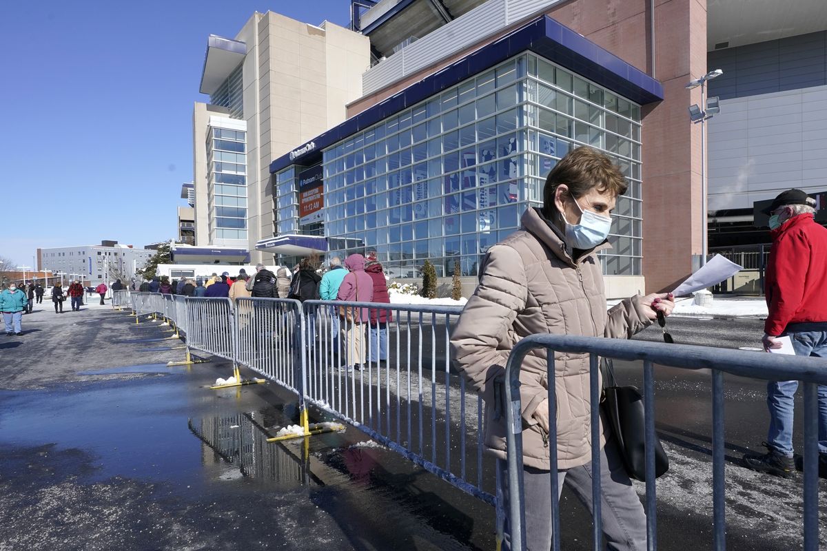 People enter a socially distanced line to get their COVID-19 vaccinations at Gillette Stadium, Monday, Feb. 8, 2021, in Foxborough, Mass.  (Steven Senne)