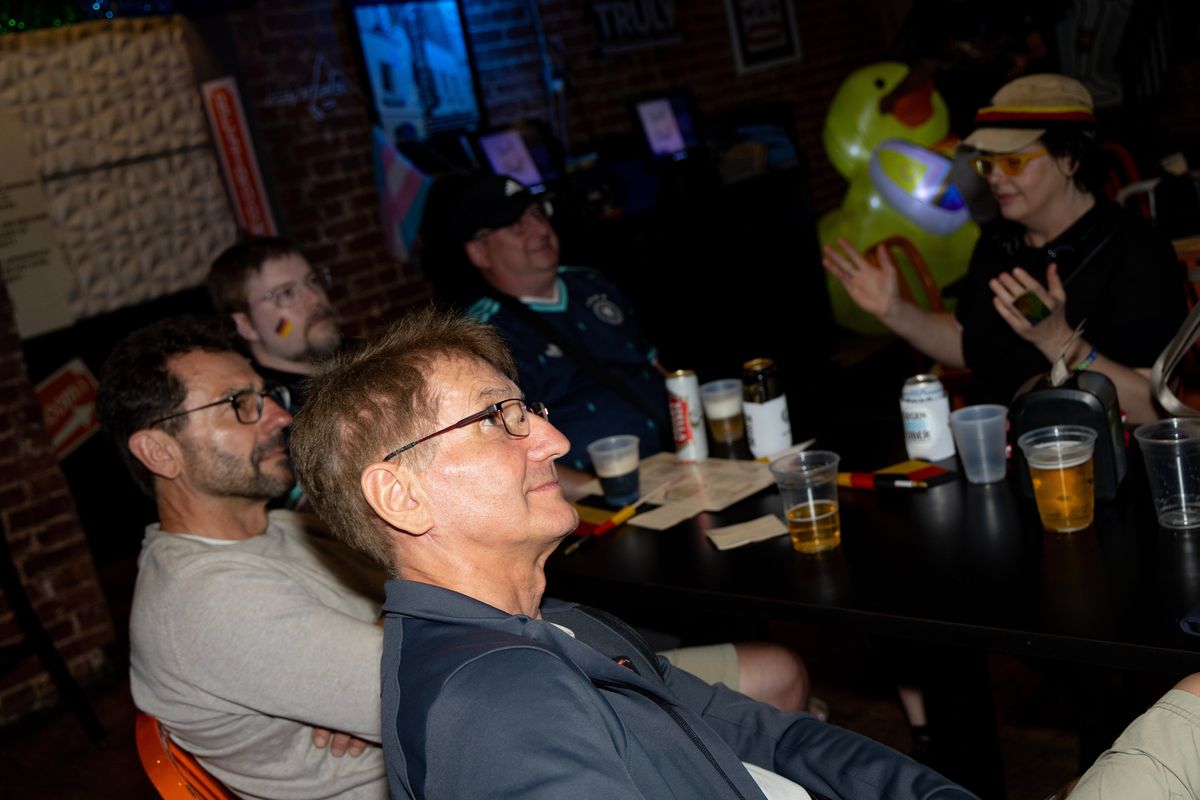 Klaus Steinbrenner, foreground, watches the Germany-Ecuador World Cup match on Thursday with his brother Marcus, to his left, and other German fans Thursday at Pitchers bar in D.C. The thermostat was set at a “sensible 72,” but at least one German wanted it warmer. (Christine Kao/The Washington Post)  (Christine Kao/The Washington Post)