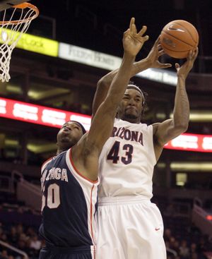Arizona forward Jordan Hill, right, grabs a rebound over Gonzaga forward Ira Brown, left, in the first half of an NCAA college basketball game Sunday, Dec. 14, 2008, in Phoenix. (Paul Connors / Associated Press)