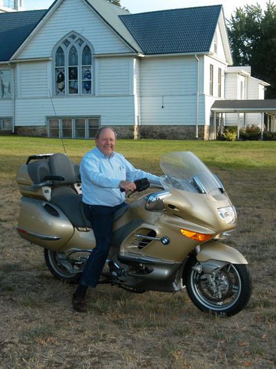 The Rev. Dan Berg, pastor of Open Door Congregational United Church of Christ in Deer Park, is pictured in front of the church on his primary means of transportation. Courtesy of The Fig Tree (Courtesy of The Fig Tree / The Spokesman-Review)