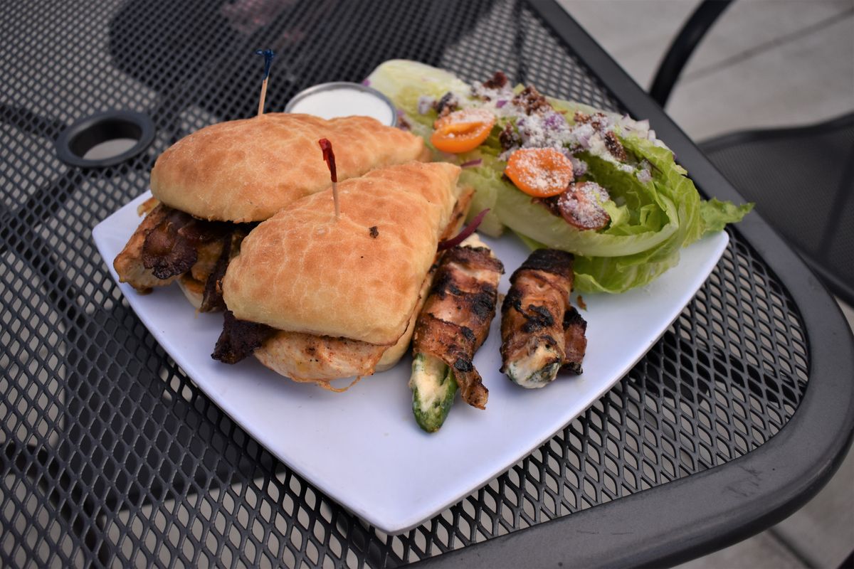 A chicken sandwich, wedge salad and jalapeno poppers at Prohibition Gastropub on Saturday afternoon.  (Don Chareunsy/The Spokesman-Review)