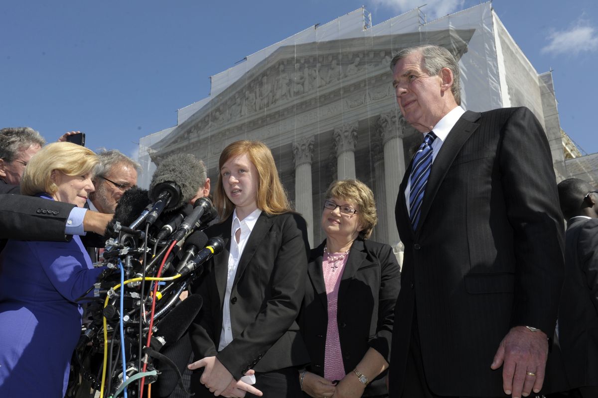 Abigail Fisher, the Texan involved in the University of Texas affirmative action case, accompanied by her attorney Bert Rein, right, talks to reporters outside the Supreme Court in Washington, Wednesday, Oct. 10, 2012. The Supreme Court is taking up a challenge to a University of Texas program that considers race in some college admissions. The case could produce new limits on affirmative action at universities, or roll it back entirely. The University of Texas at Austin President Bill Powers is at right. (Susan Walsh / Associated Press)