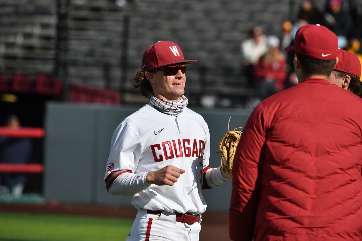 Washington State infielder Jack Smith greets teammates during the Cougars