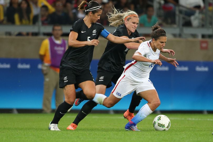 USA’s Carli Lloyd, right, battles New Zealand’s Hannah Wilkinson, center, and Abby Erceg for the ball on Wednesday. (Eugenio Savio / Associated Press)