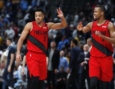 Portland Trail Blazers guard CJ McCollum, left, congratulates guard Rodney Hood as time runs out in the second half of Game 2 of an NBA basketball second-round playoff series against the Denver Nuggets Wednesday, May 1, 2019, in Denver. Portland won 97-90. (AP Photo/David Zalubowski) ORG XMIT: CODZ138 (David Zalubowski / AP)
