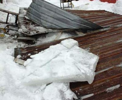This metal roof of a lean-to porch collapsed on two men at a residence in the Rathdrum area on Wednesday. (Photo courtesy of Northern Lakes Fire District via Coeur d'Alene Press)