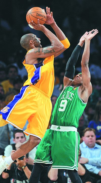 Lakers guard Kobe Bryant shoots over Celtics guard Rajon Rondo during first-half action Tuesday. (Associated Press)