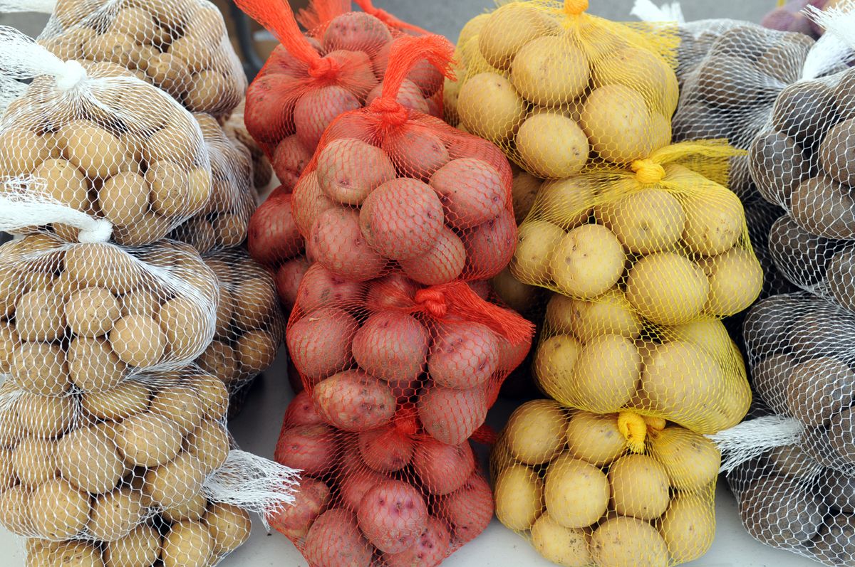Olsen Farms offered potatoes Saturday at the Spokane Farmers Market, held in a lot on West Second Avenue between Division and Browne streets.  (Jesse Tinsley / The Spokesman-Review)