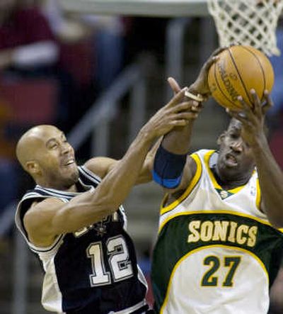 
The Spurs' Bruce Bowen and the Sonics' Johan Petro battle for a first-half rebound. 
 (Associated Press / The Spokesman-Review)