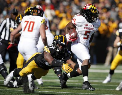 In this Saturday, Oct. 20, 2018 photo, Maryland running back Anthony McFarland (5) is tackled by Iowa defensive end Chauncey Golston (57) during the second half of an NCAA college football game, in Iowa City, Iowa. McFarland started only five games as a freshman, yet still managed to top the 1,000-yard mark. He raised eyebrows around the Big Ten after running for 298 yards against Ohio State. Now he’s poised to become one of the league’s dominant backs. (Charlie Neibergall / Associated Press)