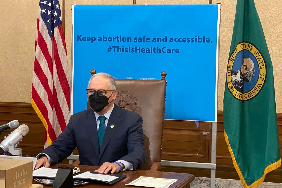 Washington Gov. Jay Inslee is seen in Olympia on Thursday before signing a measure that prohibits legal action against both people seeking an abortion and those who aid them. Inslee’s signature comes days after the Legislature in neighboring Idaho approved a bill modeled on a law in Texas that allows lawsuits to enforce a ban on abortions performed after six weeks of pregnancy.  (Associated Press)