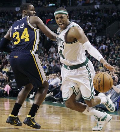 Boston’s Paul Pierce, right, drives against Utah’s C.J. Miles during second-half action of a Celtics victory on Wednesday. (Associated Press)