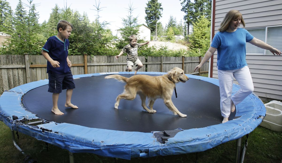 Jenna Kagan shares the family trampoline with her sons Joey, 7, left, and Hunter, 6, and the family dog Daisy at home in Maple Valley, Wash., near Seattle. Associated Press photos (Associated Press photos / The Spokesman-Review)