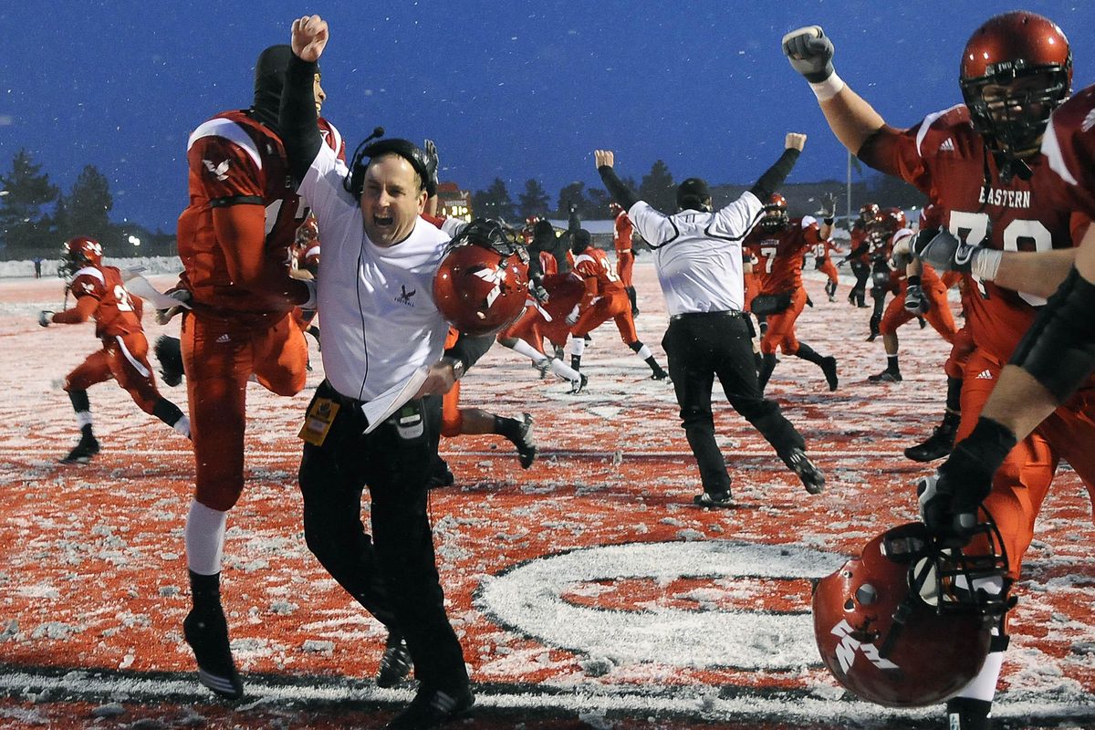 Eastern Washington University head football coach, Beau Baldwin (facing camera) celebrates with his team after an overtime victory over North Dakota State, Saturday Dec. 11, 2010 in Cheney, Wash. (Dan Pelle / The Spokesman-Review)