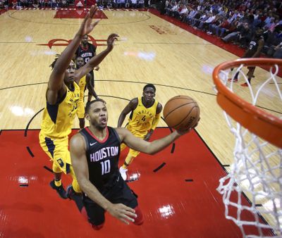 Houston Rockets guard Eric Gordon (10) drives to the basket past Indiana Pacers center Myles Turner, left, during Wednesday’s game. (Eric Christian Smith / Associated Press)