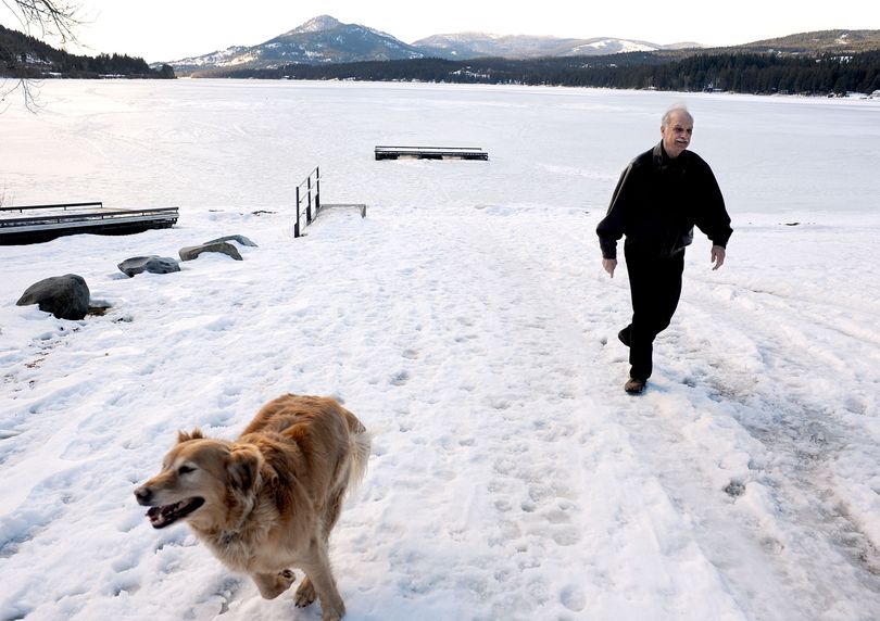 “We love this lake,” said Chuck Gladish as he walked with his dog Gypsy near Cocolalla Lake on Thursday. The Idaho Legislature will likely vote this morning to approve minimum water levels for the lake. Gladish is president of the lake homeowners association, which spearheaded the move. (Kathy Plonka)