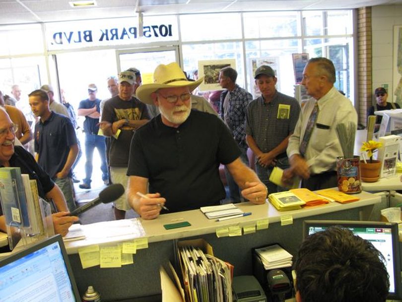 J.D. Dennis of Kuna purchases the first wolf-hunting tag sold at the Idaho Fish & Game headquarters in Boise on Monday morning.  (Betsy Russell / The Spokesman-Review)