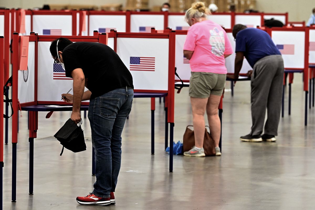 Voters fill out their ballots during in person voting in the Kentucky Primary at the Kentucky Exposition Center in Louisville, Ky., Tuesday, June 23, 2020. In an attempt to prevent the spread of the coronavirus, neighborhood precincts were closed and voters that didn