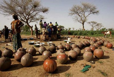 
Women collect water from a pit in makeshift water containers in the small village of Dan Mallam, Niger, on Sunday. 
 (Associated Press / The Spokesman-Review)
