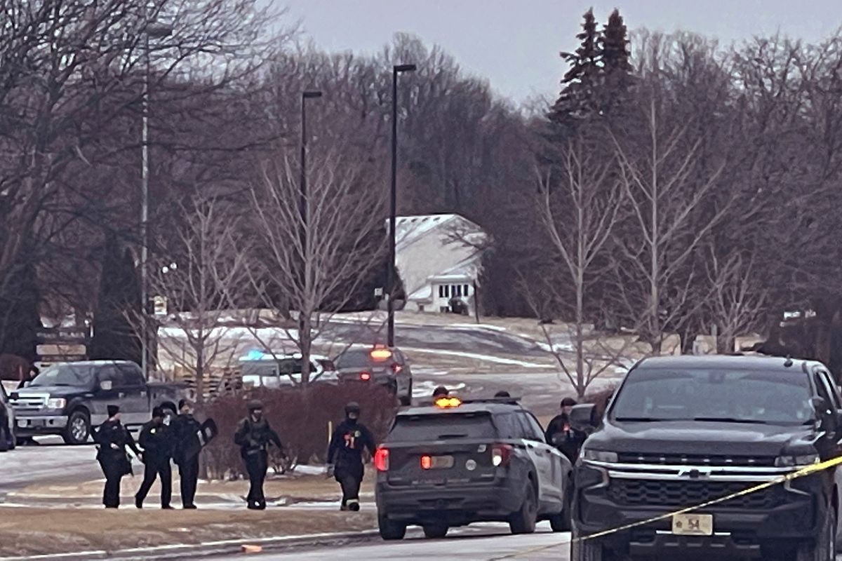 Police are seen walking from Park Plaza Apartments Saturday, Feb. 5, 2022 where there was a shooting in Brown Deer, Wis. Police say two people were killed and two more were injured in a shooting at an apartment complex in the Milwaukee suburb. (Ebony Cox)