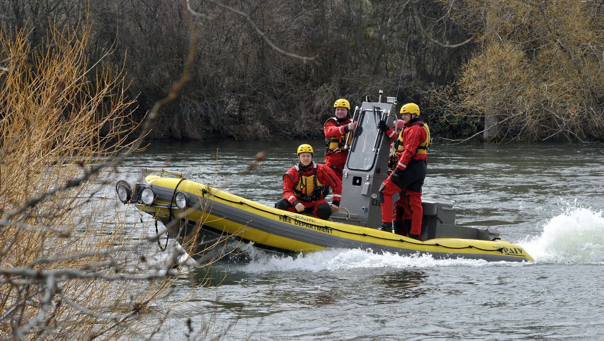 Spokane Fire Department Water Rescue Team patrols the Spokane River along Upriver Drive, after witness reported a person in the water near Greene Street Bridge, Tuesday morning, April 10, 2012.  The search was called off. (Dan Pelle / The Spokesman-Review)
