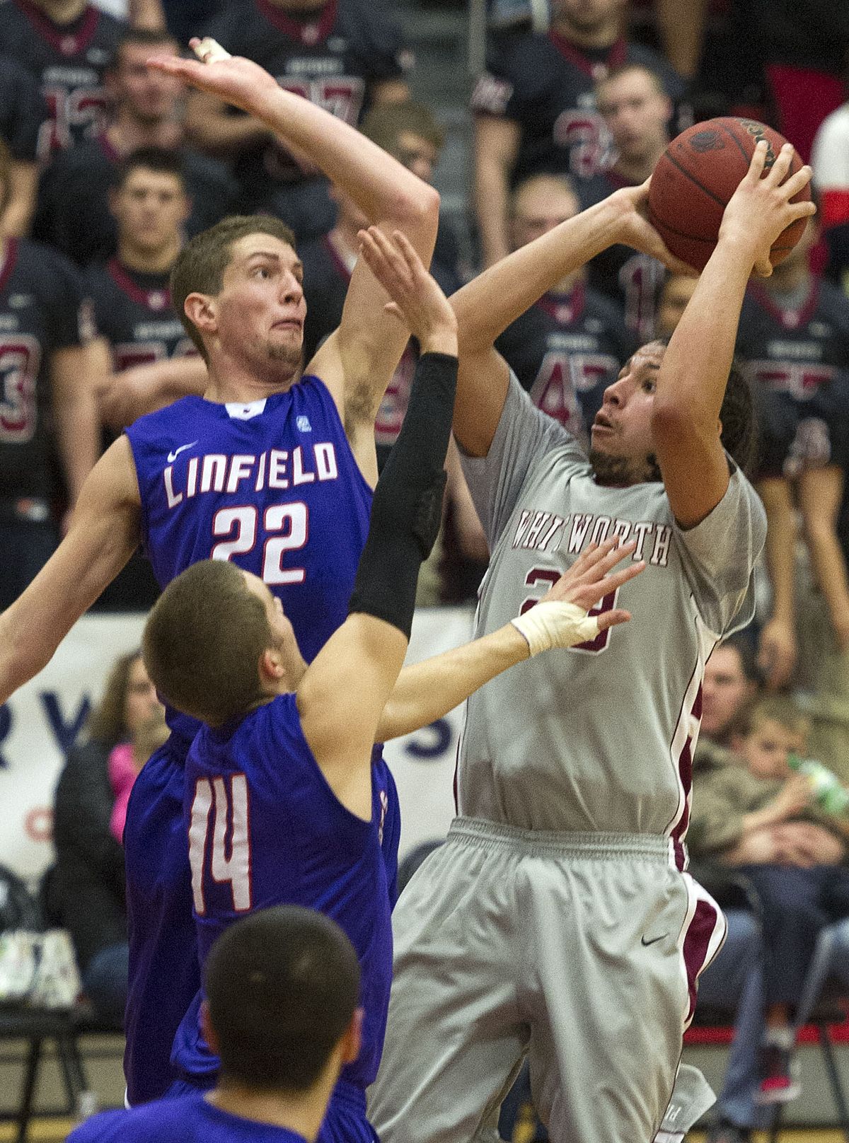 Whitworth guard Kenny Love takes a shot as Linfield guard Adam Myren fouls. (Colin Mulvany)