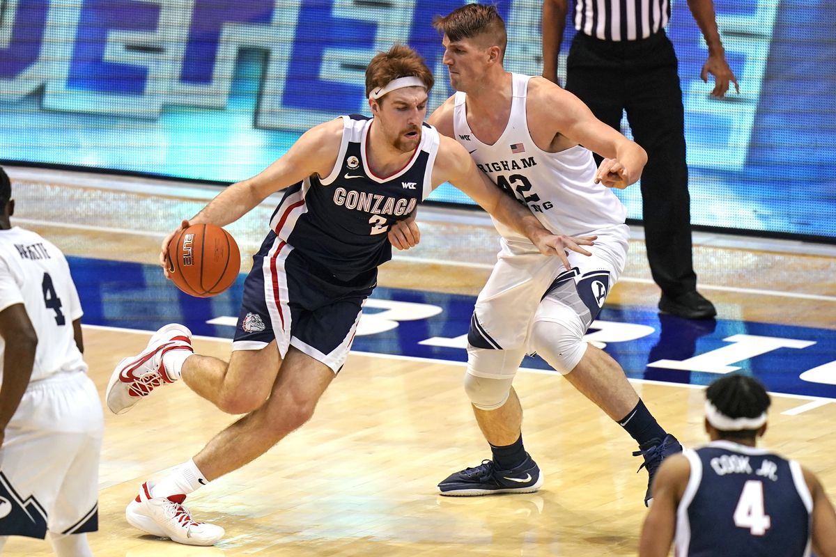 Gonzaga forward Drew Timme drives as BYU center Richard Harward defends during the first half on Monday night in Provo, Utah. Timme scored 20 points and grabbed a game-high 13 rebounds in the Bulldogs’ 82-71 victory.  (Associated Press)