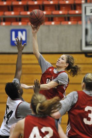 Brianne Ryan, driving for a layup at practice, followed in her mom’s footsteps by playing at Eastern. Sister Kayleigh redshirted this season. (Jesse Tinsley)