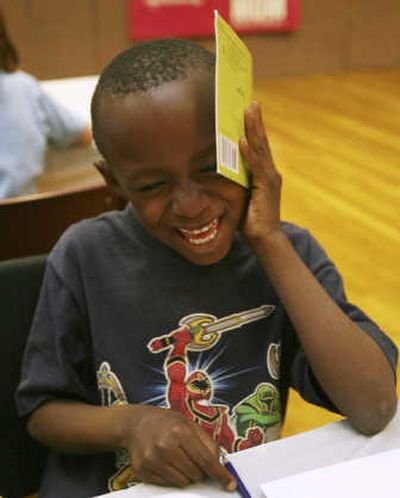 Kierston Skyer, 7, giggles as he listens to his recorded voice on a Mother's Day greeting card for his mother at Fort Bliss, Texas. Associated Press photos
(Associated Press photos / The Spokesman-Review)