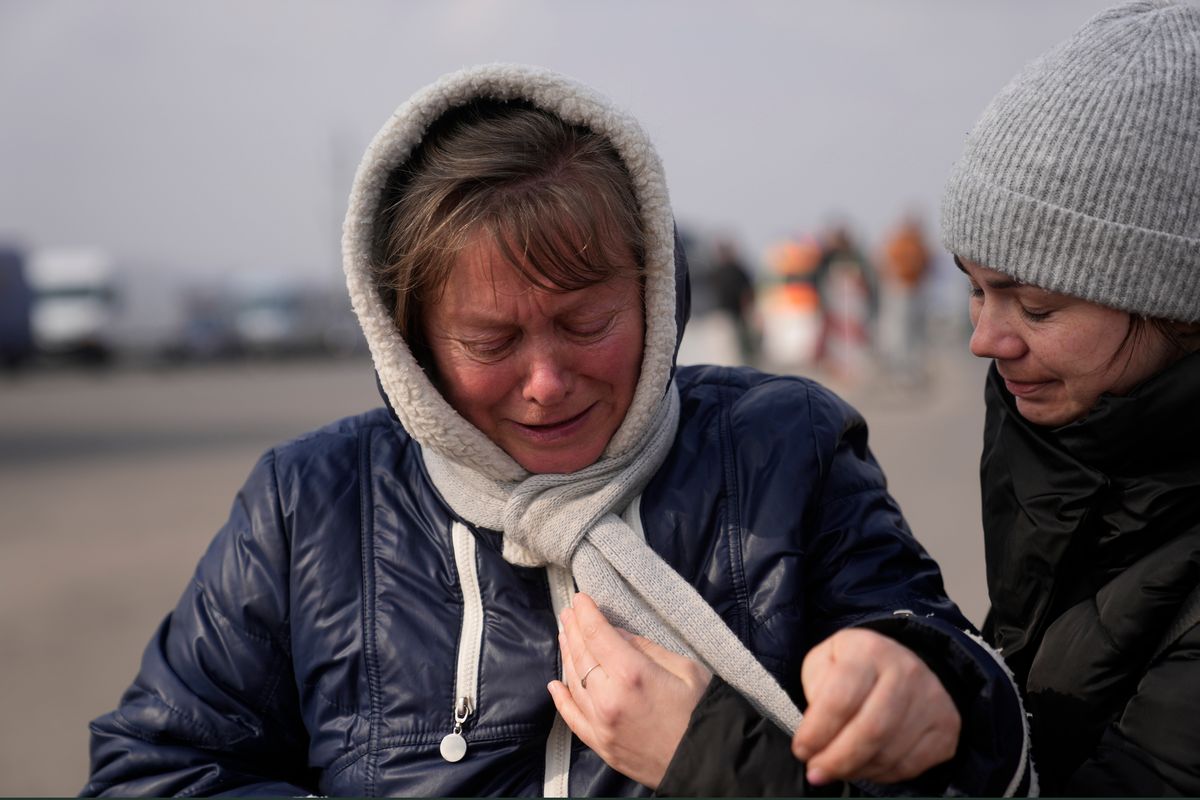 A woman fleeing from Ukraine is overcome by emotions Friday at the border crossing in Medyka, Poland.  (Markus Schreiber)