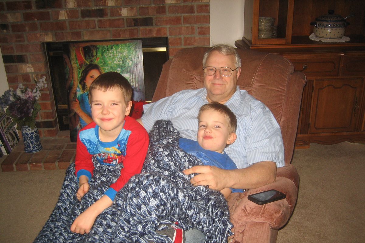 In this undated photo provided by Chuck and Judy Cox, Chuck Cox sits with his grandsons, Charlie, left, and Braden, right, at the Coxes’ home in Puyallup, Wash. (Associated Press)