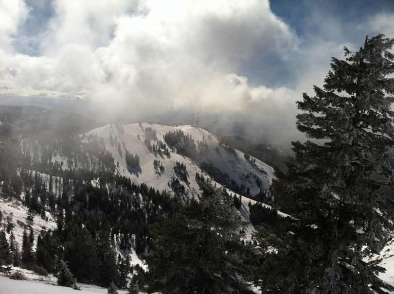 Sun slants through low clouds atop Bogus Basin on Sunday (Betsy Russell)