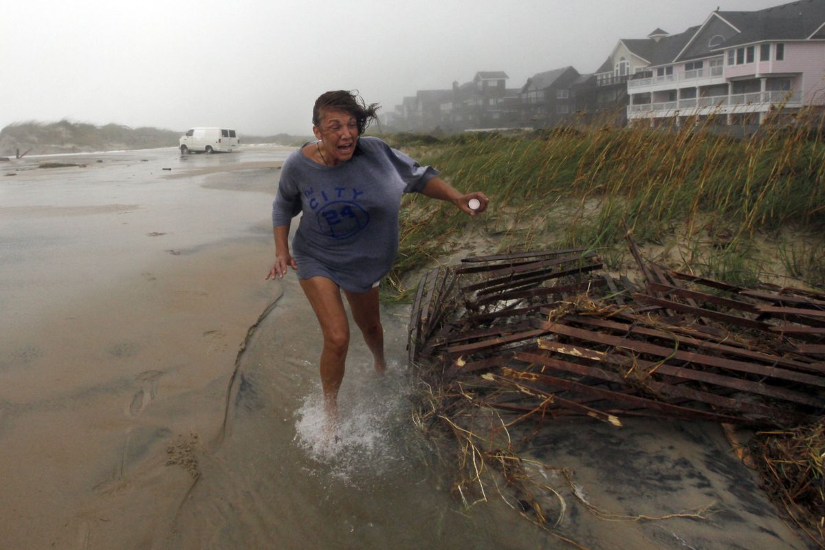 Jackie Sparnackel abandons her van near the Frisco Pier on Saturday after she drove up to inspect the storm-battered structure in Frisco, N.C., and became stuck. (Associated Press)