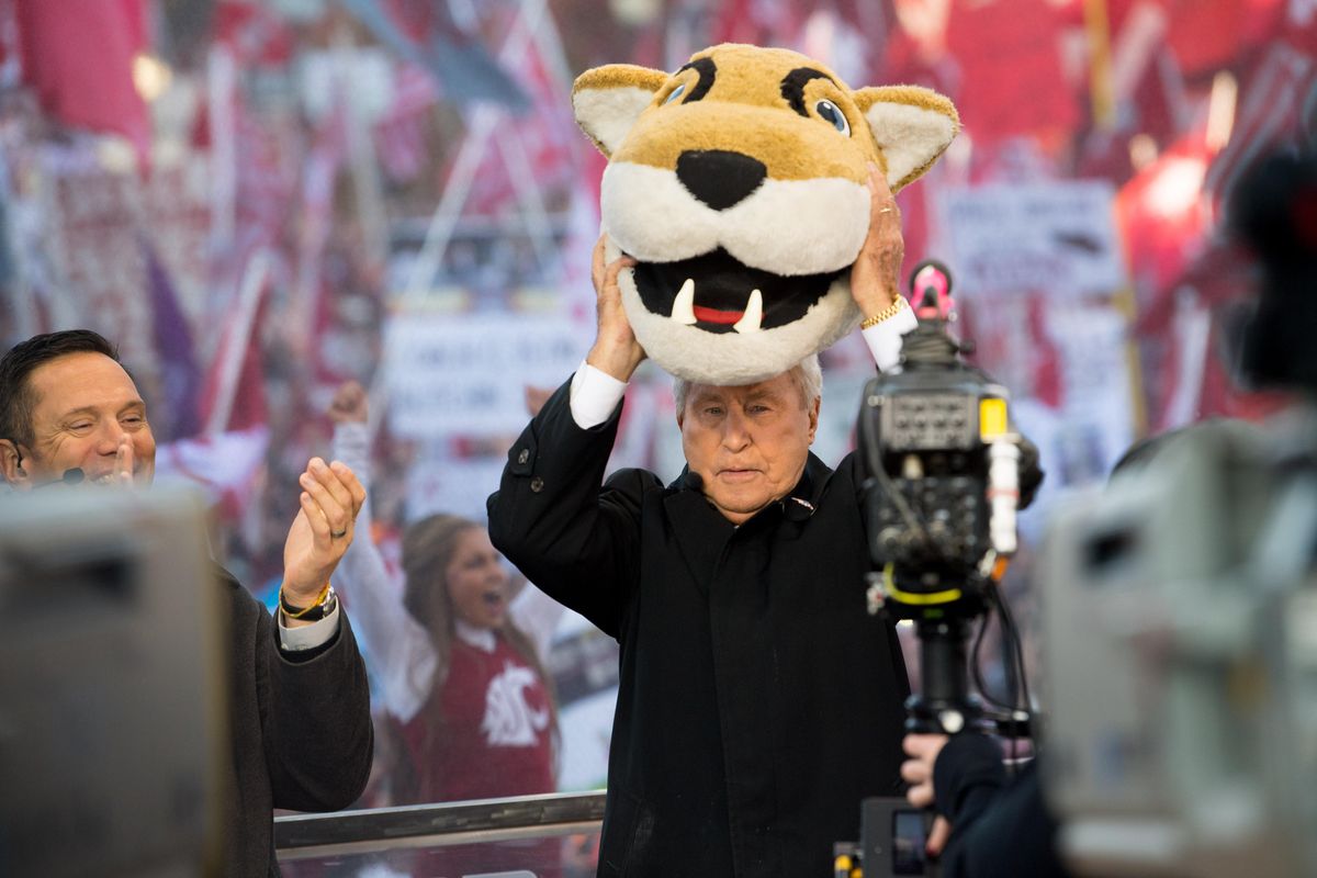 Lee Corso holds the Cougar mascot head high, indicating his prediction of a WSU win in the closing minutes of Saturday’s ESPN GameDay show, much to the delight of former WSU quarterback Drew Bledsoe, left, and the raucous WSU crowd. (Tyler Tjomsland / The Spokesman-Review)