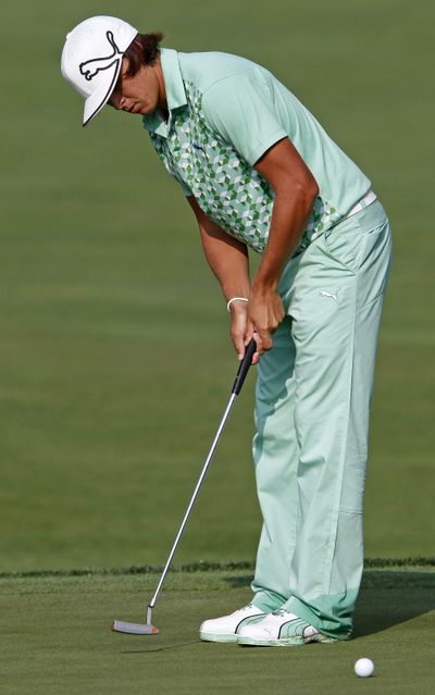 Rickie Fowler watches his putt on the par-4 13th hole Friday.  (Associated Press)