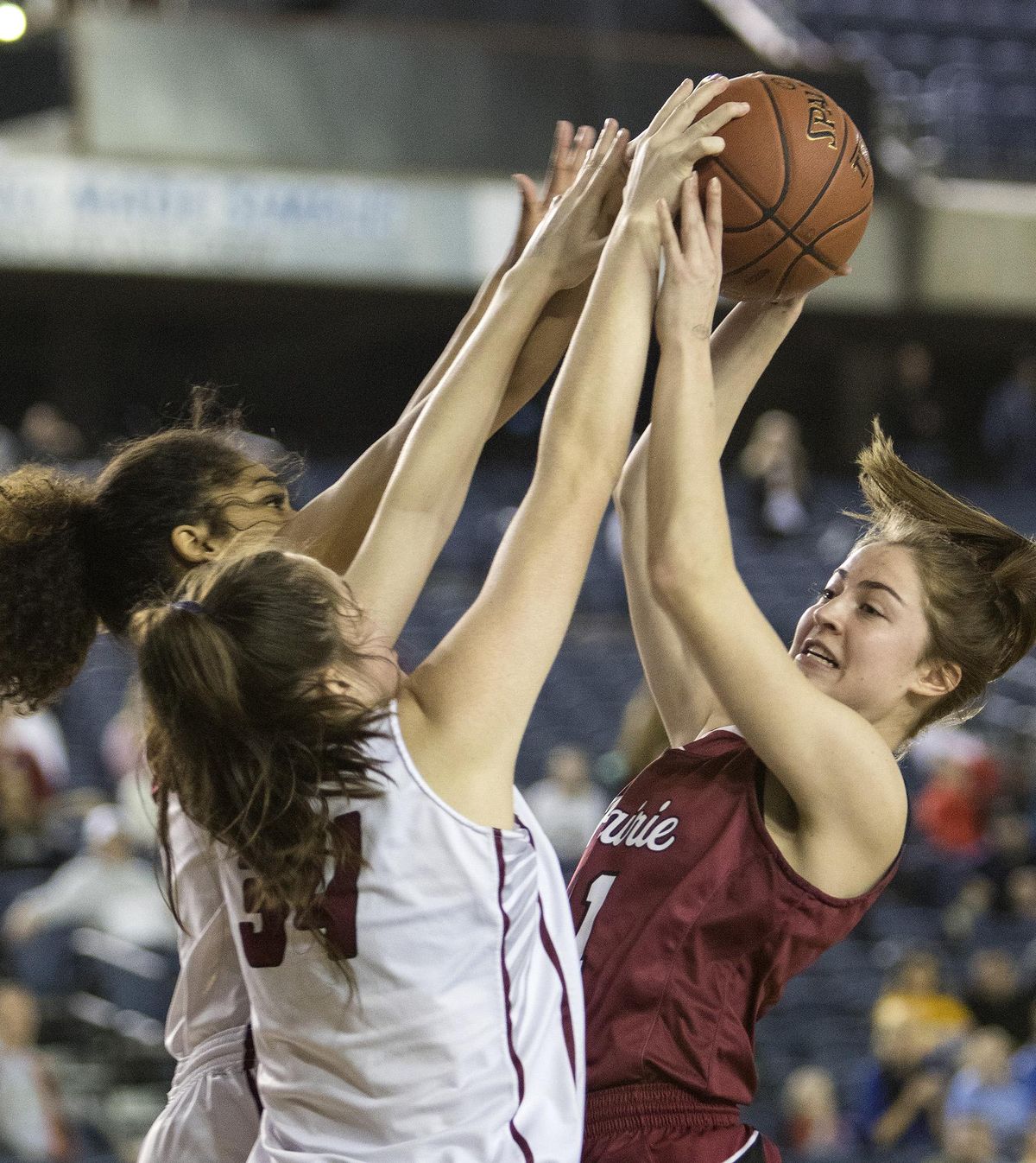 Mt. Spokane’s Jayda Noble, far left, and Emily Nelson, left, stuff Prairie’s Cassidy Gardner during action in the State 3A girls championship game Saturday  in Tacoma. Mt. Spokane fell to Prairie 37-35. (Patrick Hagerty / For The Spokesman-Review)