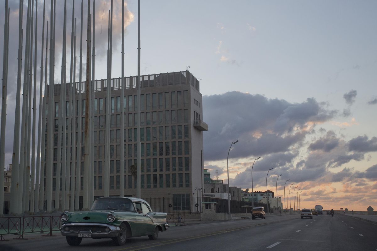 A classic American car moves past the U.S. Interests Section building in Havana on Dec. 17. A half century after Washington severed relations with Cuba, the mission is set to be a full-fledged embassy. (Associated Press)