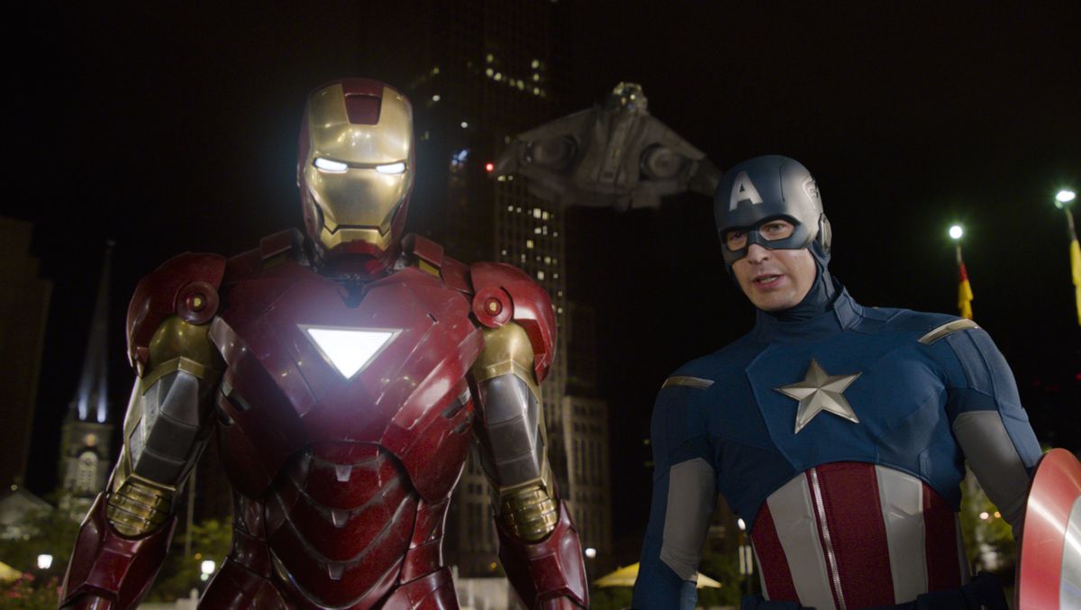 Iron Man, portrayed by Robert Downey Jr., left, and Captain America, portrayed by Chris Evans, perform a scene from “The Avengers.” (Associated Press)