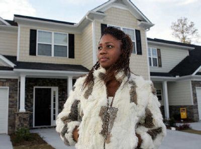 Anita Alston poses in front of her new home in Lithonia, Ga.. Alston, 23, and Katrina Lawson are the first two in the nation to buy homes through a new program geared toward teaching former and current foster children the financial skills most young adults lean on parents, siblings or family friends to learn.
(Associated Press / The Spokesman-Review)