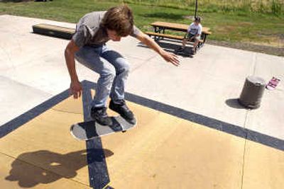 
Jake Billington, 14, attempts a varial on one of the ramps at the Fairfield skate park at Thiel Park. He travels from nearby Waverly to Fairfield almost every day to practice his skateboarding skills. Trevor Curry, seated, was one of the top fundraisers for the park. 
 (J. BART RAYNIAK / The Spokesman-Review)