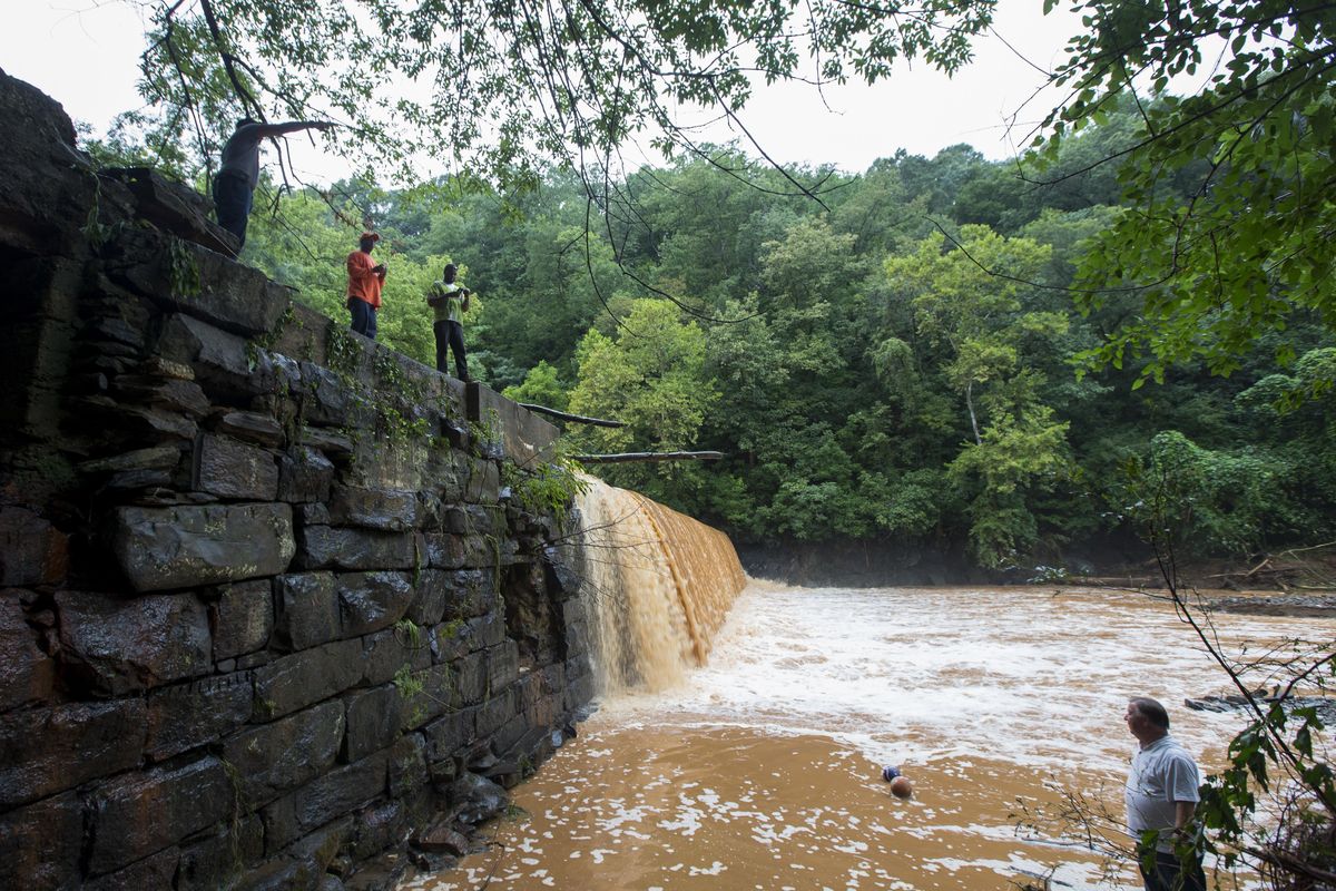 The Hollins Mill dam is overrun with water on Friday, Aug. 3, 2018, in Lynchburg, Va. The Hollins Mill dam, which is fed from College Lake Dam through the Blackwater Creek, flooded after a deluge of rain hit the city the night before. (Jill Nance / AP)