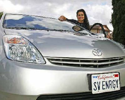 
In a file photo Sheila Catoira, a San Diego elementary school teacher, poses with her Toyota hybrid Prius in San Diego in April.  
 (Associated Press / The Spokesman-Review)