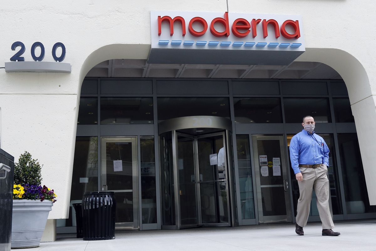 FILE - A man stands outside an entrance to a Moderna, Inc., building, Monday, May 18, 2020, in Cambridge, Mass. A second COVID-19 vaccine moved closer to joining the U.S. fight against the pandemic Thursday, Dec. 17, 2020 as government experts convened for a final public review of its safety and effectiveness. The shot from Moderna and the National Institutes of Health is urgently needed as the country continues to record ever-higher numbers of new cases, hospitalizations and deaths ahead of more holiday travel and family gatherings. FDA