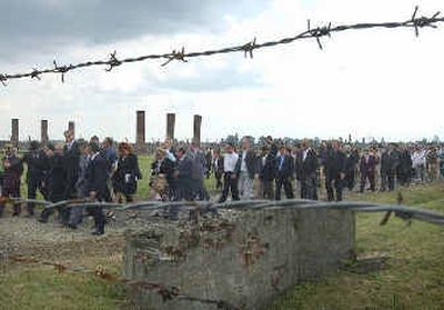 
Gypsies from across Europe march from the former inmate barracks to the ruins of a gas chamber on  Monday at the site of the Auschwitz-Birkenau Nazi death camp while commemorating the 60th anniversary of the last Nazi killings of Gypsies at the camp.  
 (Associated Press / The Spokesman-Review)