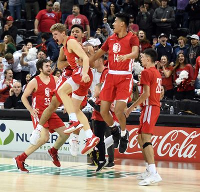 Brewster celebrates their 60-57 win over St. George’s during a State 2B boys semifinal game on Friday, March 6, 2020, at the Spokane Arena. (Colin Mulvany / The Spokesman-Review)