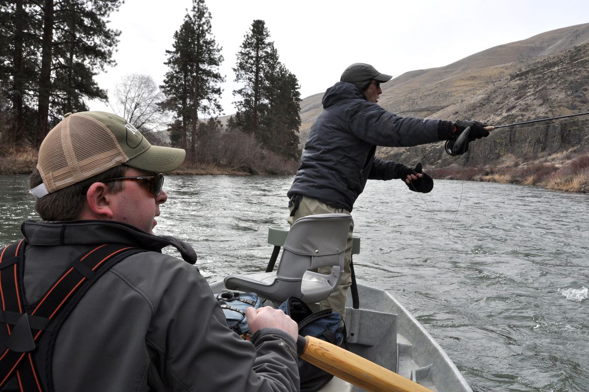 AHEAD OF THE CROWD: Fly-fishing guide Mike Kennedy rows while David Moershel casts skwala nymph patterns on the Yakima River. (Rich Landers)