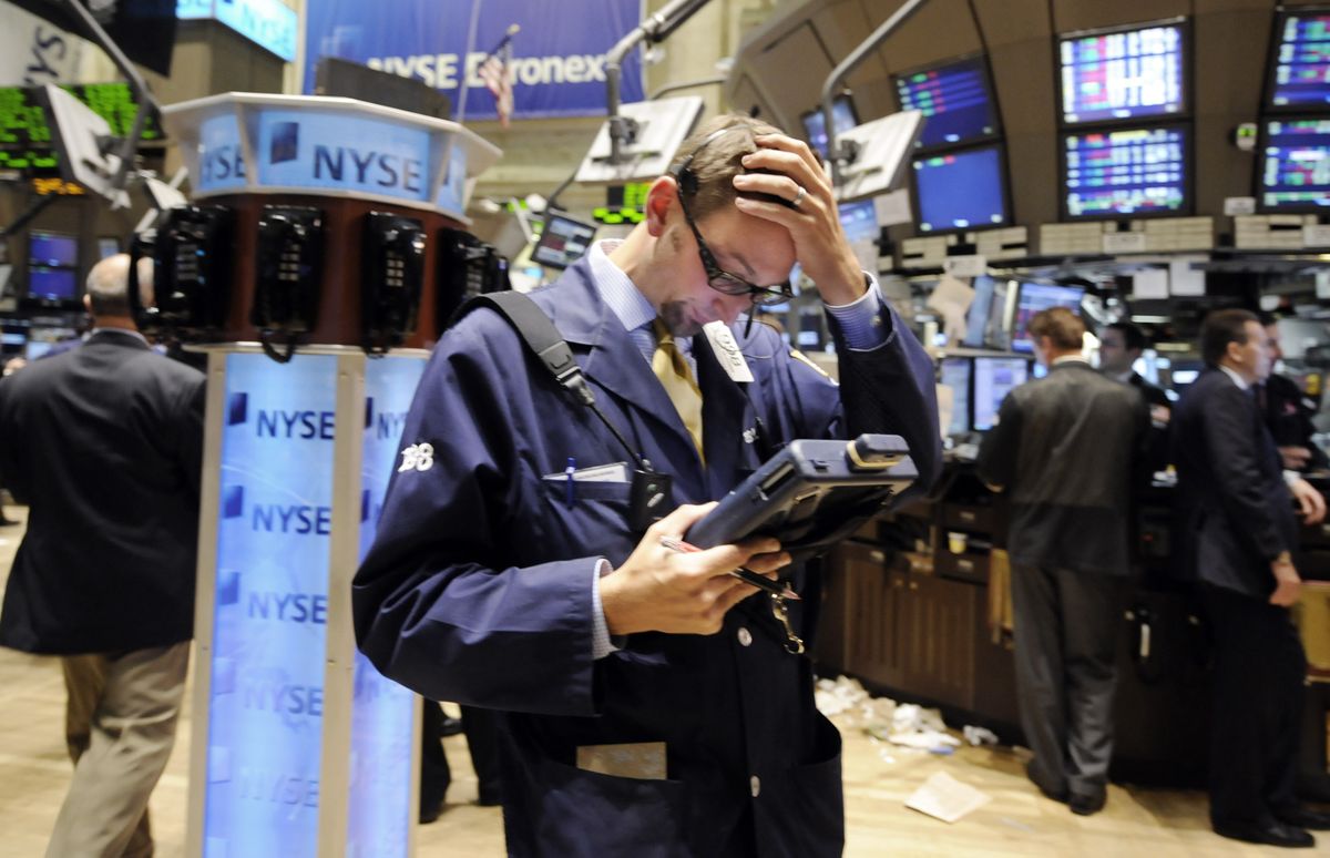 Trader Bradley Silverman works on the floor of the New York Stock Exchange on Tuesday. Stocks ended lower for the fifth straight session. The Dow fell 508.39, or 5.11 percent, to 9,447.11. Associated Press photos (Associated Press photos / The Spokesman-Review)