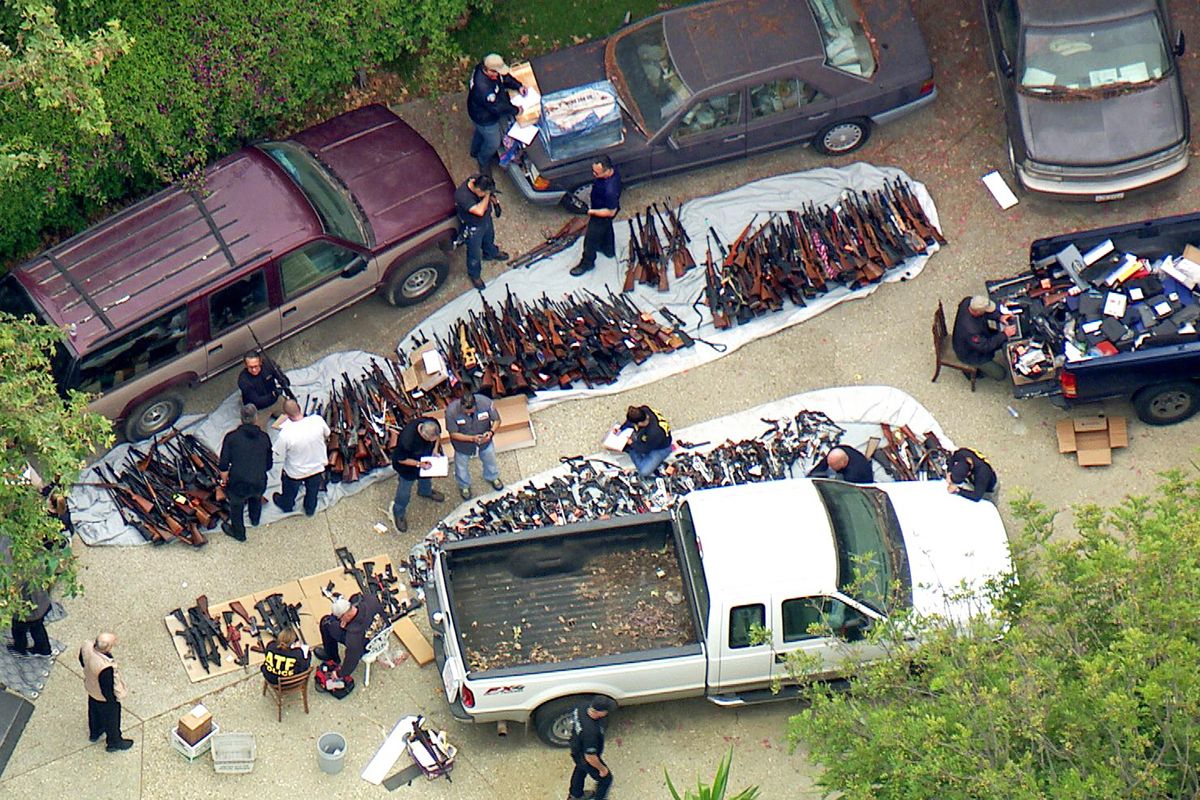 This photo from video provided by KCBS/KCAL-TV shows investigators from the U.S. Bureau of Alcohol, Tobacco, Firearms and Explosives and the police inspecting a large cache of weapons seized at a home in the affluent Holmby Hills area of Los Angeles on Wednesday, May 8, 2019. Authorities seized more than a thousand guns from the home after getting an anonymous tip regarding illegal firearms sales in a posh area near the Playboy Mansion and served a search warrant around 4 a.m. Wednesday at the property on the border of the Bel Air and Holmby Hills neighborhoods. (KCBC/KCAL / Associated Press)